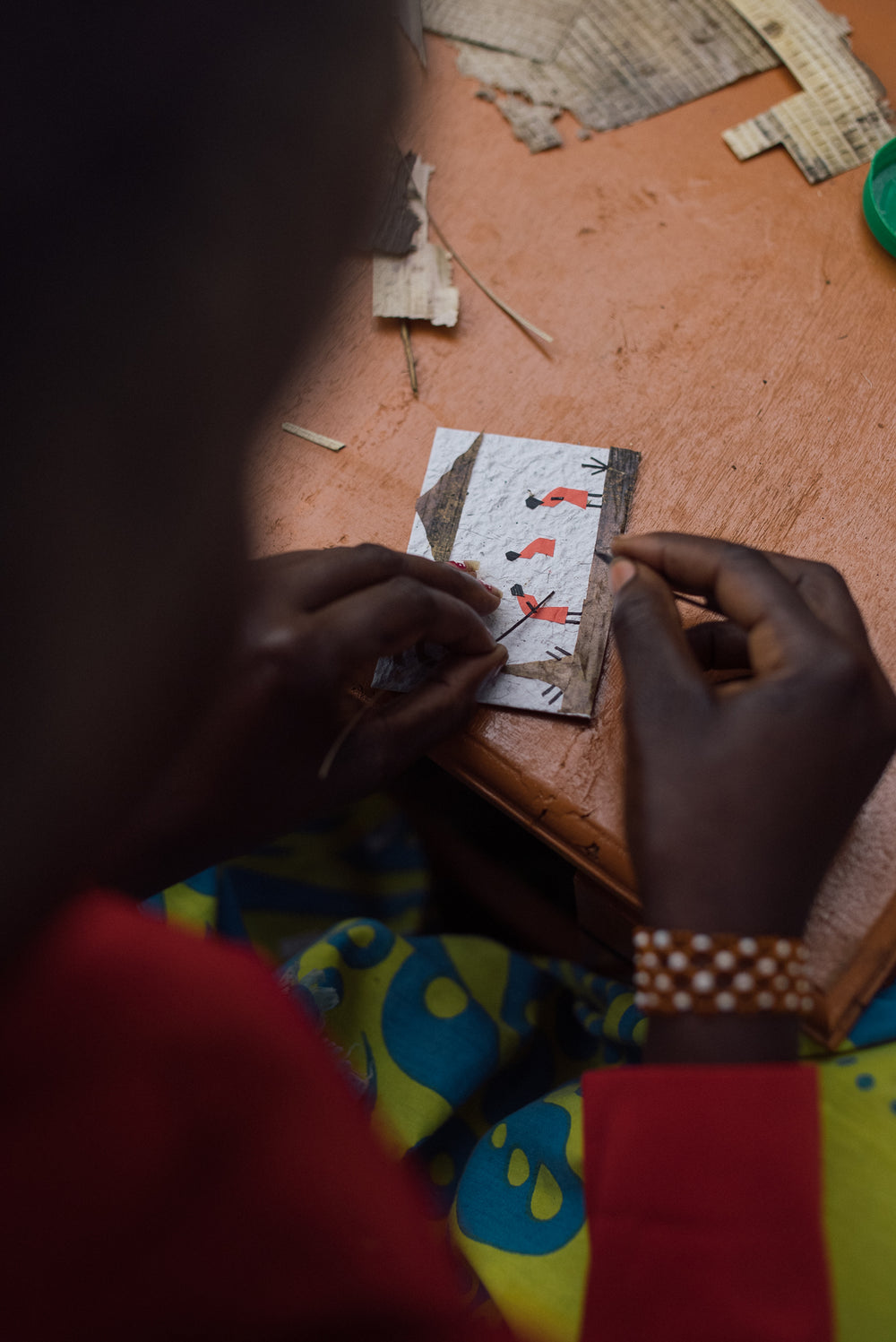A woman in western Kenya handcrafting an Ajiri banana-bark label