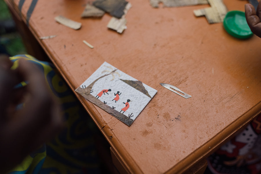A finished Ajiri tea label, handmade from banana bark and handmade paper, on a work table in western Kenya