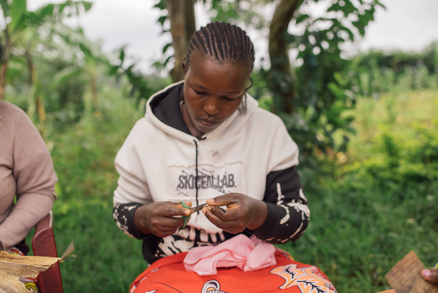 An Ajiri artisan in western Kenya carefully cutting banana bark for a tea label