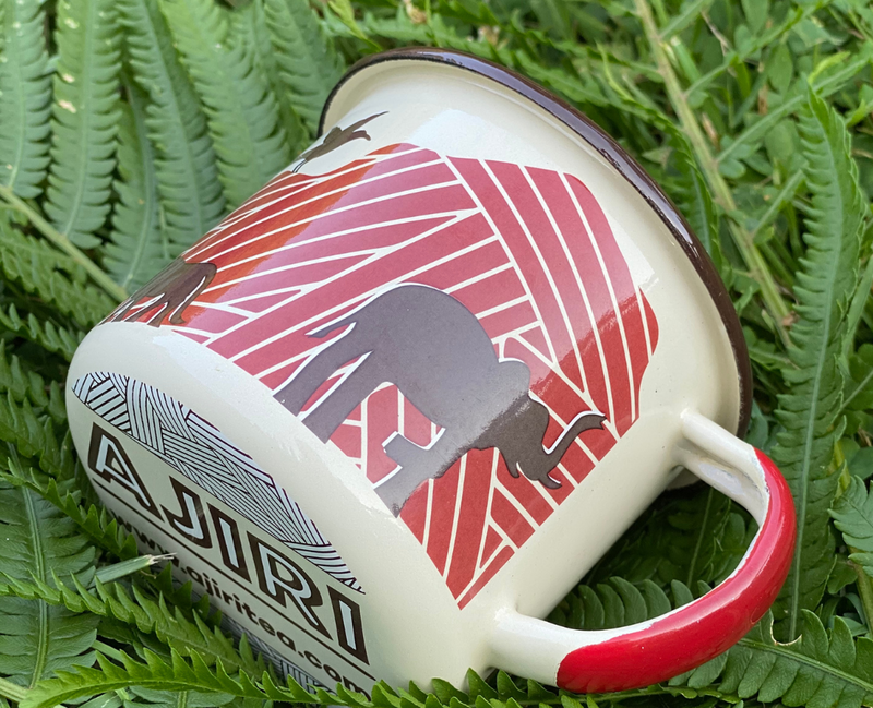 White enamel camping mug with red decoration ideal for camping trips, outdoor adventures, or unpredictable toddlers. 